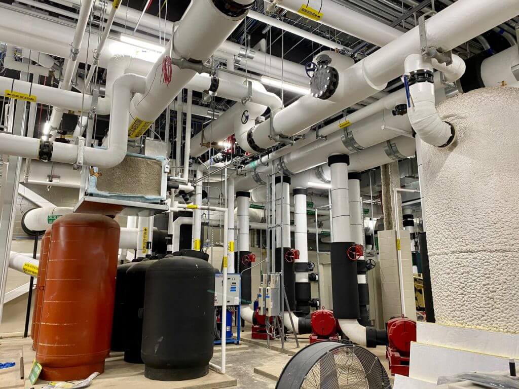 Color coated pipes and equipment in an industrial space